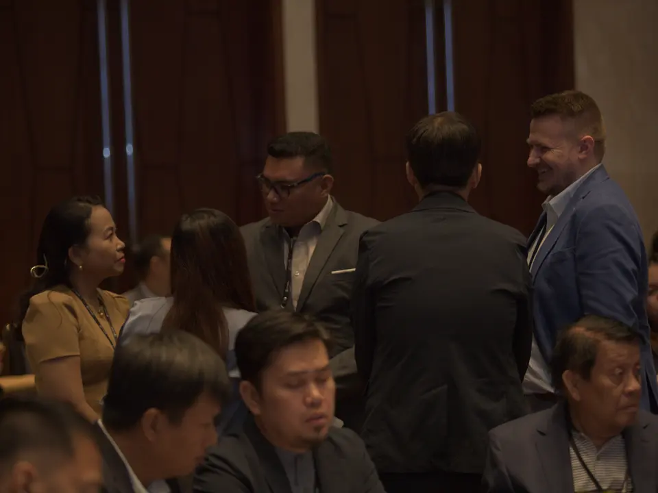 Renewable energy conference delegates networking between sessions