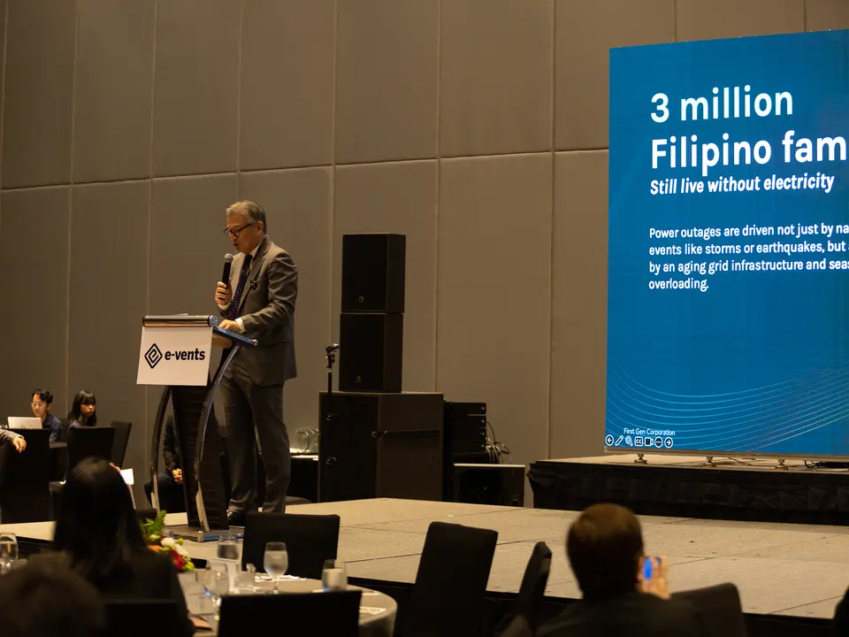Energy industry speaker presenting electricity access data on stage