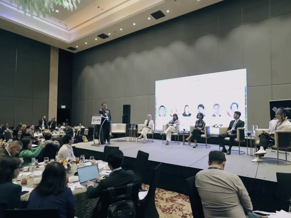 Audience watching a renewable energy panel in the conference hall