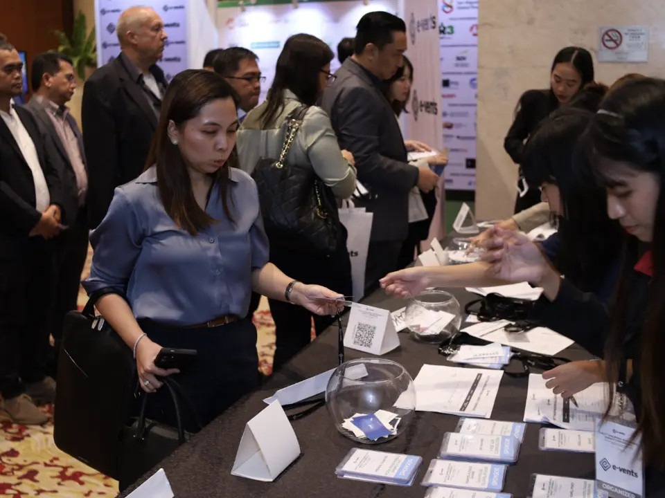 Conference guests checking in at the registration desk