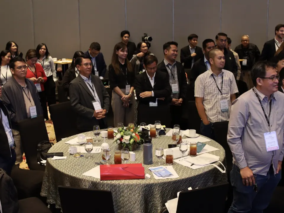 Renewable energy delegates standing beside their conference tables