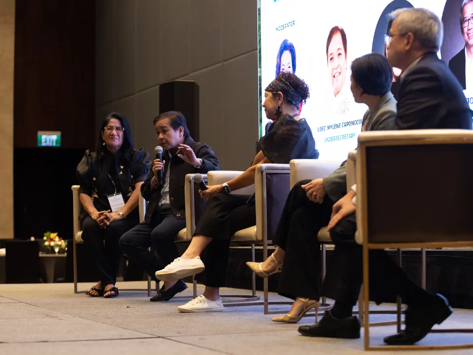 Panelists discussing renewable energy topics on stage
