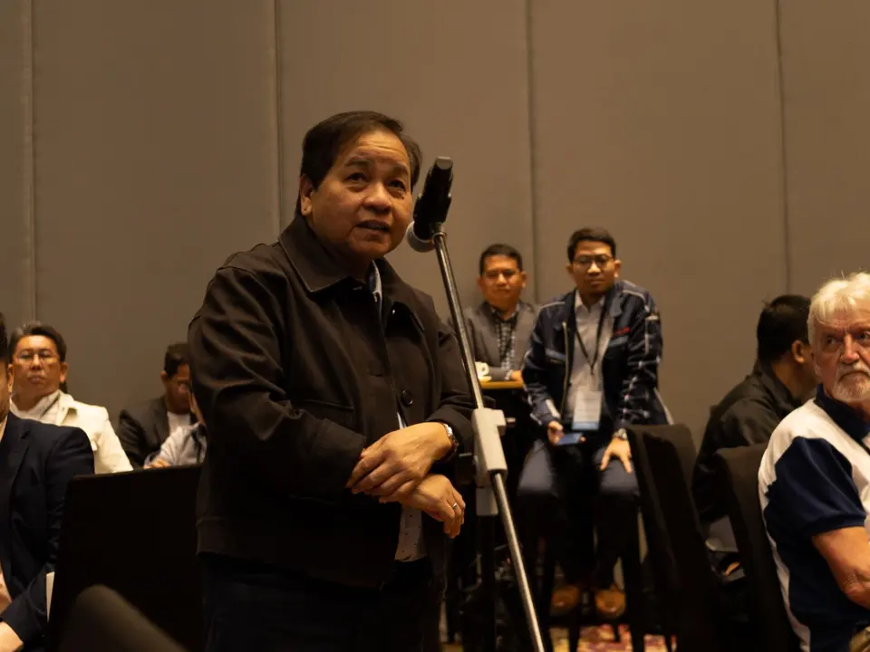 Delegate speaking into a microphone during the audience question session