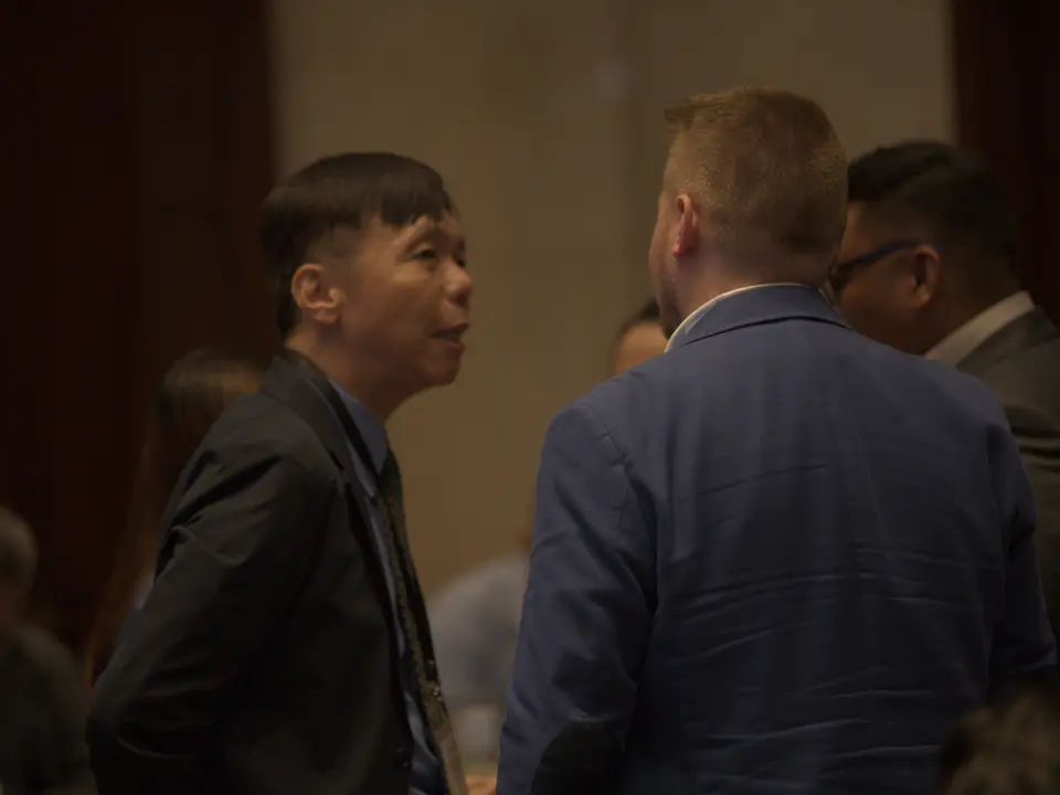 Renewable energy professionals talking during a networking break