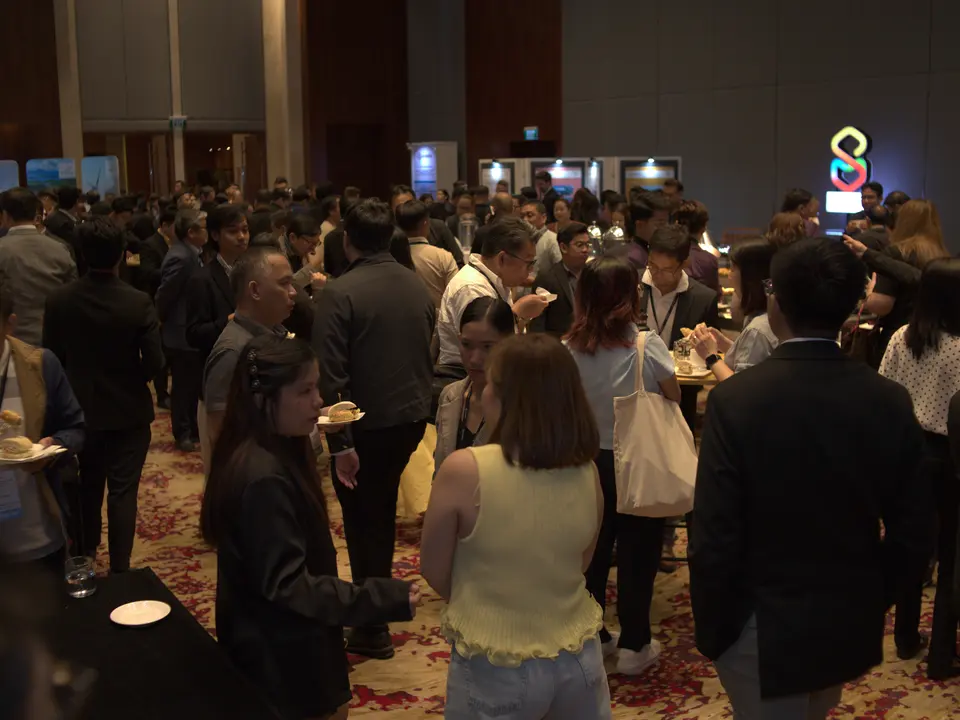 Crowd of delegates networking in the conference exhibition area
