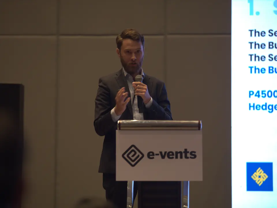 Energy market speaker presenting electricity pricing information