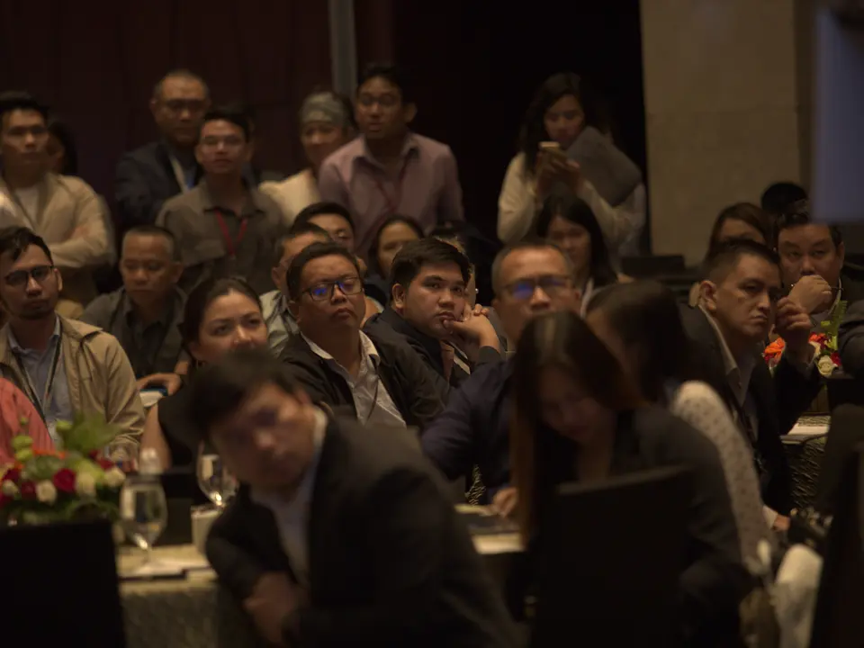 Conference delegates listening to a presentation from their tables