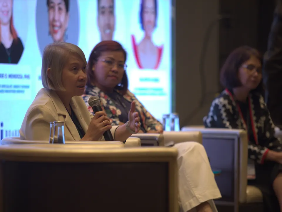 Two renewable energy experts speaking during a panel session